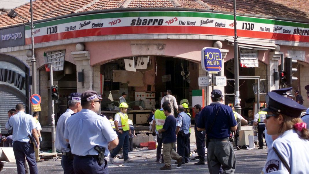 A gaping hole is left in the shop front of the Sbarro pizzeria after a suicide bombing that killed at least 18 people and wounded more than 80 others in Jerusalem August 9, 2001. In the worst bombing in Jerusalem since the start of a Palestinian uprising last September, the suicide bomber blew himself up at the restaurant during the busy lunch hour. Six of the dead are children. NB/GB