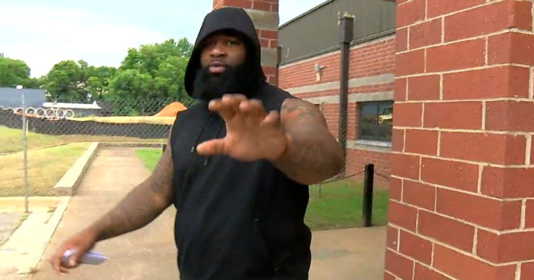 Kansas City Chiefs defensive lineman Isaiah Buggs reaches out toward a news camera after bonding out of jail.