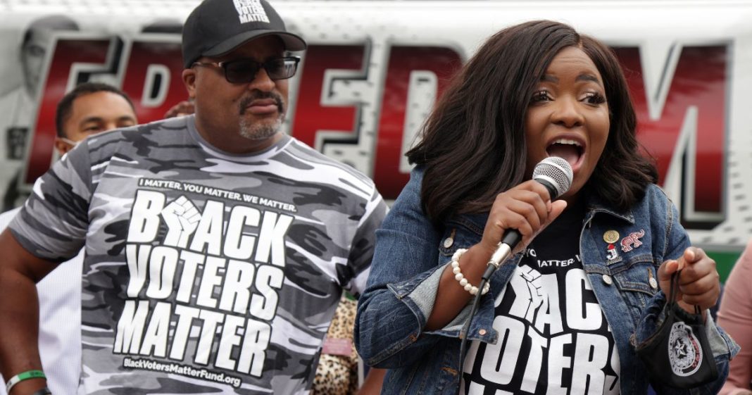 Texas State Rep. Jasmine Crockett (D-100) (R) speaks as Co-founder and Executive Director of Black Voters Matter Cliff Albright (L) looks on during a demonstration on voting rights outside National Museum of African American History and Culture August 4, 2021 in Washington, DC.