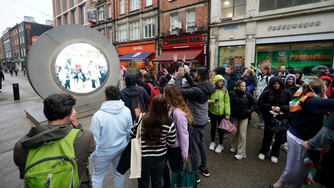 People view the live stream portal between Dublin and New York which was temporarily closed following some "inappropriate behaviour" Pic: PA 