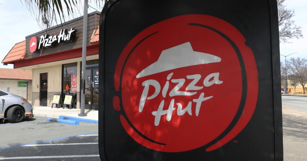 A sign is posted on the exterior of a Pizza Hut restaurant on March 25, 2024 in San Pablo, California.