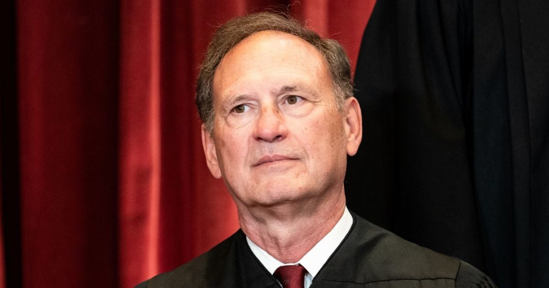 Associate Justice Samuel Alito sits during a group photo of the Justices at the Supreme Court.