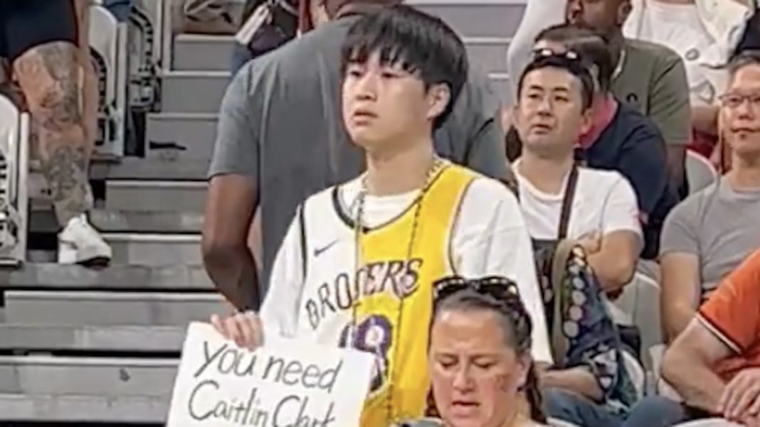 A fan at the Olympics holds a sign about Caitlin Clark