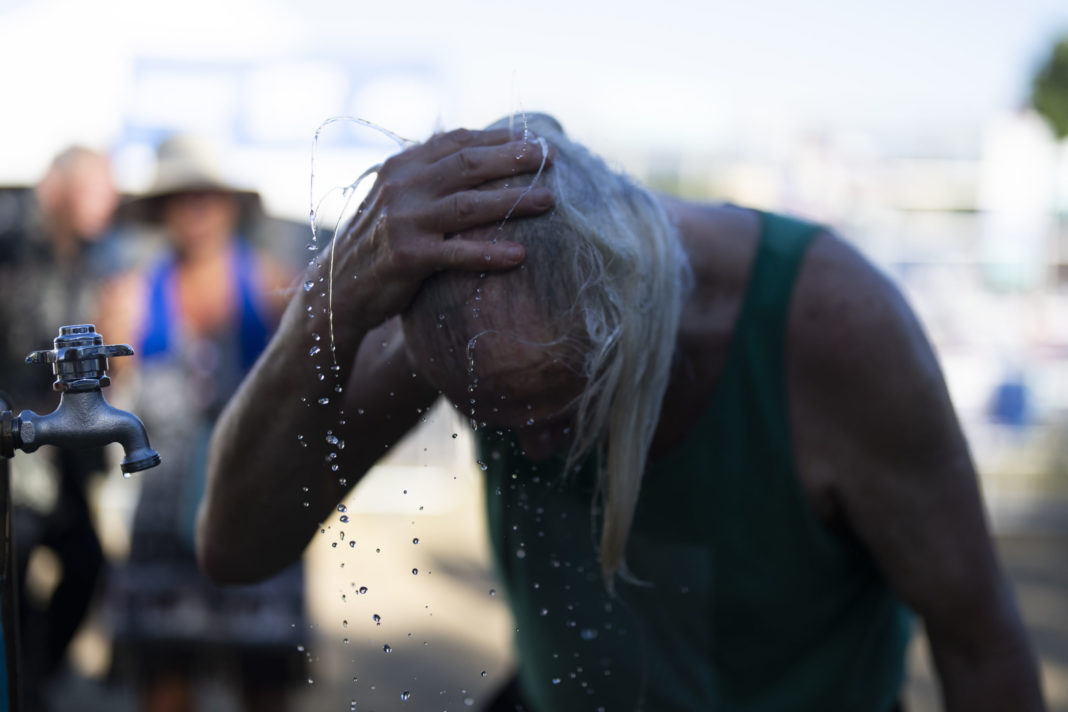 A person cools off during the Waterfront Blues Festival on Friday in Portland, Oregon.