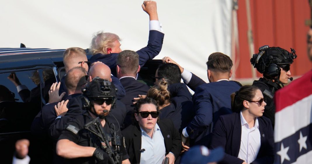 Former President Donald Trump is escorted to a motorcade following an attempted assassination at a campaign event in Butler, Pennsylvania, on Saturday.