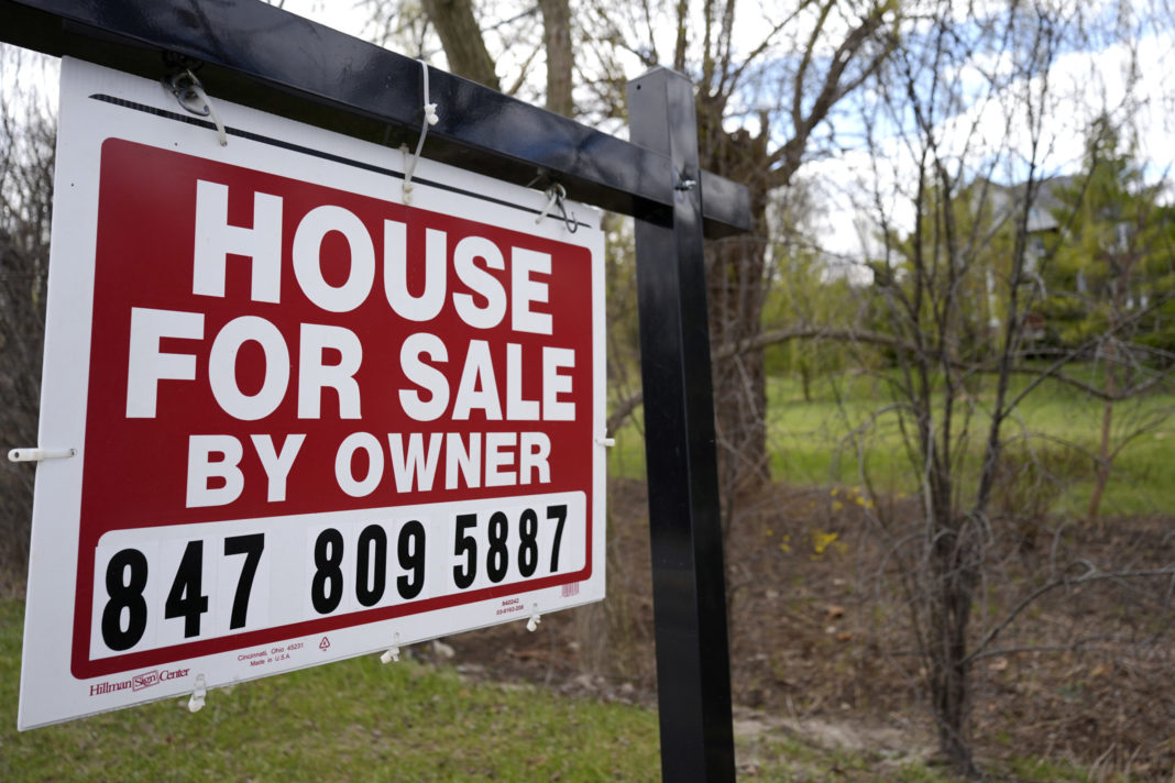 A sign announcing a house for sale is displayed in Prospect Heights, Illinois, on March 18.