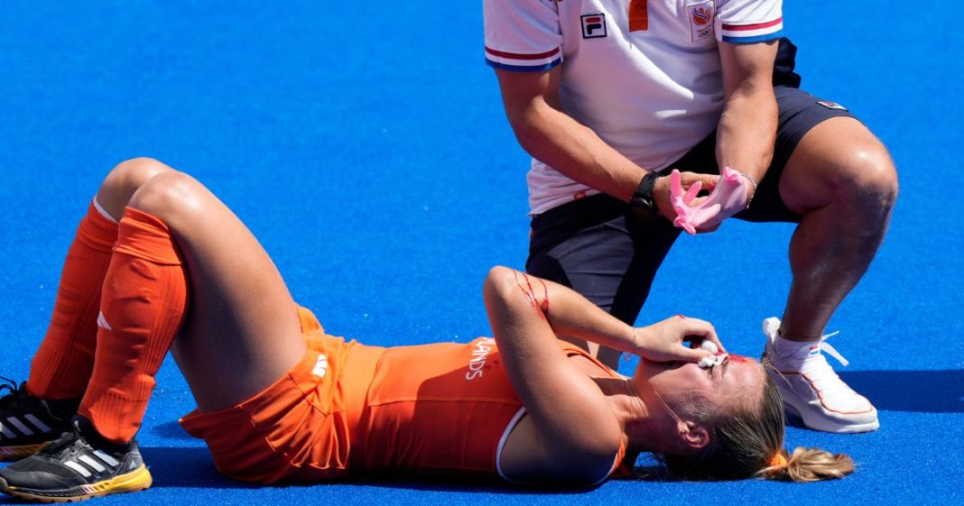 Netherlands' Joosje Burg lies on the ground after getting injured during the women's semifinal field hockey match between Argentina and Netherlands at the Yves-du-Manoir Stadium during the 2024 Summer Olympics Wednesday in Colombes, France.