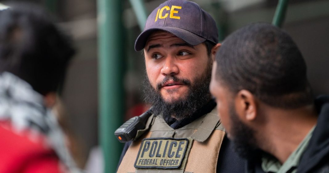 An ICE agent monitors hundreds of asylum seekers being processed upon entering the Jacob K. Javits Federal Building on June 6, 2023 in New York City. New York City has provided sanctuary to over 46,000 asylum seekers since 2013, when the city passed a law prohibiting city agencies from cooperating with federal immigration enforcement agencies unless there is a warrant for the person's arrest.