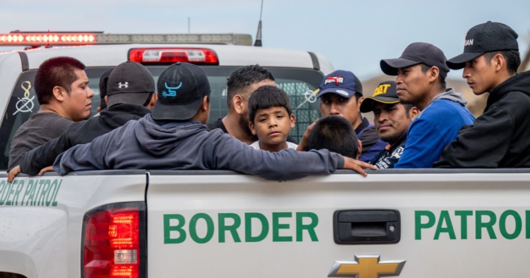 Migrants seeking asylum from Central and South America sit in the back of a border patrol vehicle after being apprehended by U.S. Customs and Border protection officers after illegally crossing over into the U.S. on June 24, 2024 in Ruby, Arizona.