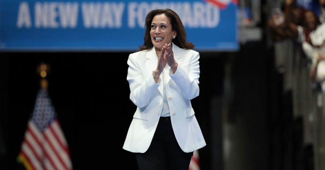 Democratic presidential nominee, U.S. Vice President Kamala Harris greets the crowd as she arrives on stage at a campaign rally at the Enmarket Arena August 29, 2024 in Savannah, Georgia.