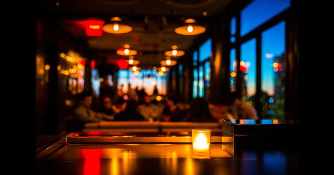 This Getty stock image shows a restaurant, with a tabletop candle in the foreground.