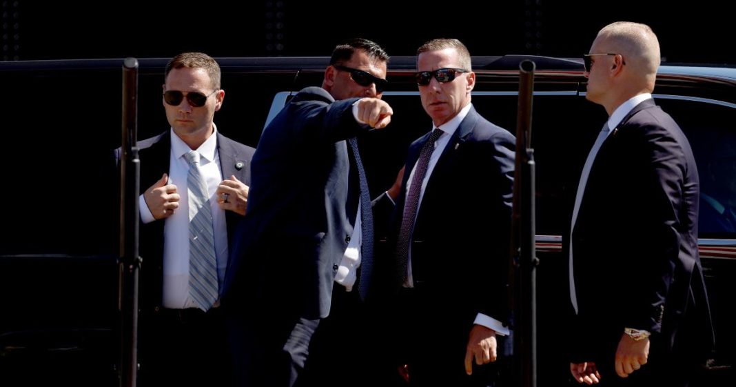 U.S. Secret Service officers look at the stage before the arrival of Republican presidential candidate former U.S. President Donald Trump at a campaign rally at the Aero Center Wilmington on September 21, 2024 in Wilmington, North Carolina.