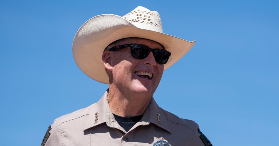 Cochise County Sheriff Mark Dannels laughs while at the U.S.-Mexico border on August 22, 2024 south of Sierra Vista, Arizona.