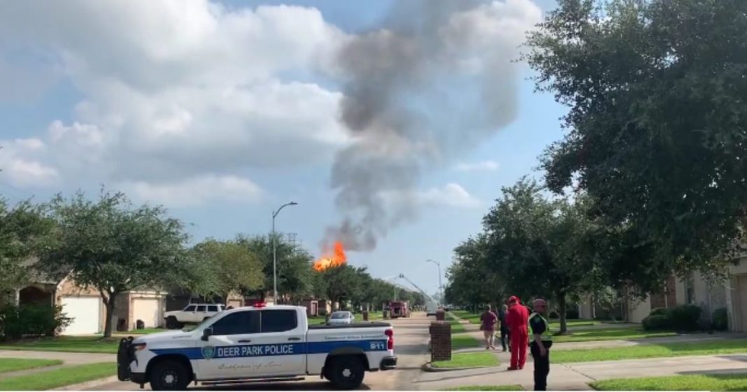 A massive fire burns near Houston, Texas, on Monday after an SUV crashed through a fence and hit a natural gas pipeline, causing some nearby residents to be evacuated.