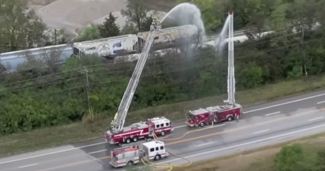 This YouTube screen shot shows first responders cooling off a new train derailment in Ohio that is leaking dangerous chemicals.