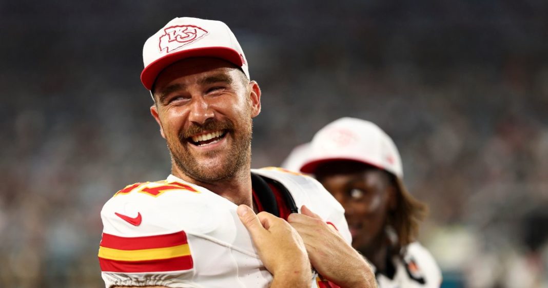 Travis Kelce #87 of the Kansas City Chiefs smiles on the sidelines during the second quarter of an NFL preseason football game against the Jacksonville Jaguars.