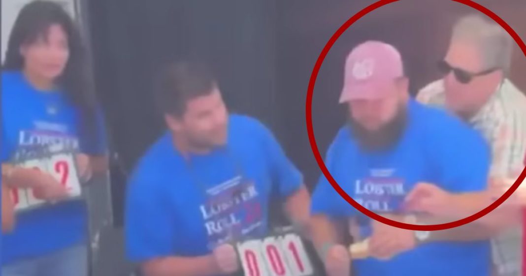 New Hampshire Gov. Chris Sununu, right, performed the Heimlich maneuver on Christian Moreno, second from right, after he began choking during a lobster roll eating contest in Hampton Beach.