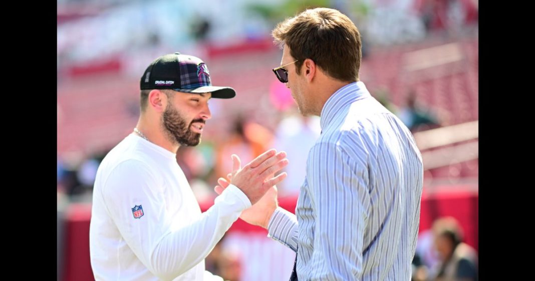 Baker Mayfield #6 of the Tampa Bay Buccaneers and former NFL player Tom Brady embrace prior to a game against the Philadelphia Eagles at Raymond James Stadium on September 29, 2024 in Tampa, Florida.