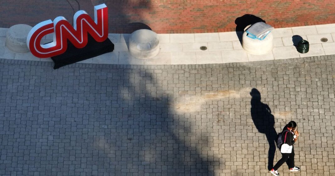 In an aerial view, a person walks past a CNN logo outside of their studios inside the Turner Entertainment Networks as final preparations are made for the CNN presidential debate on June 26, 2024 in Atlanta, Georgia.