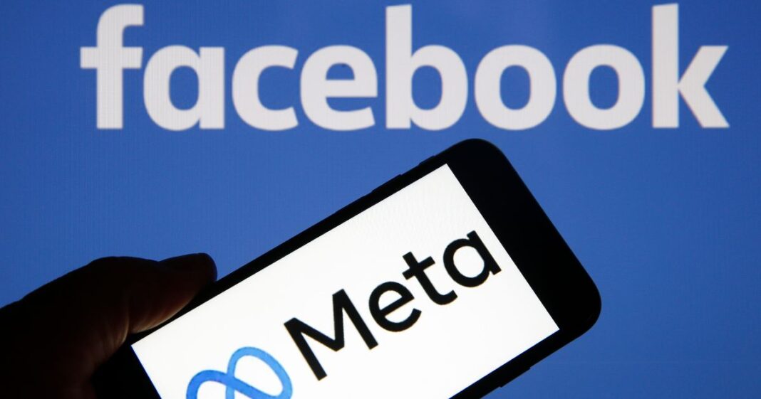 The Meta logo is displayed on the screen of an iPhone in front of a Facebook logo in Paris, France, on Oct. 29, 2021.