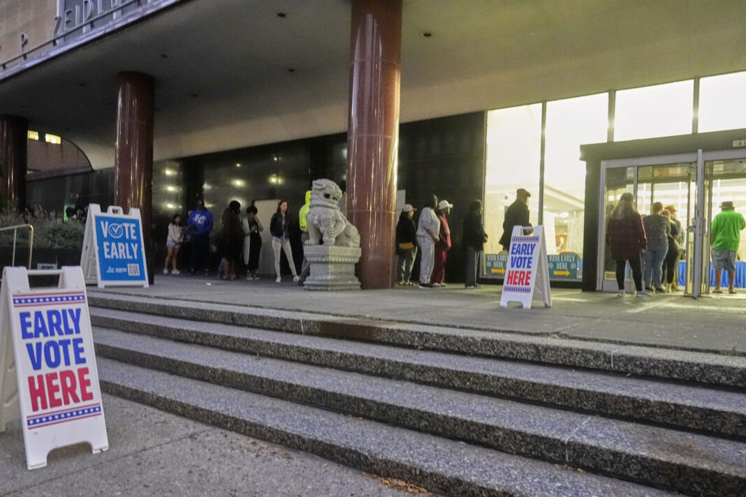 People line up outside the Frank P. Zeidler Municipal Building during the first day of Wisconsin's in-person absentee voting in Milwaukee on Tuesday.