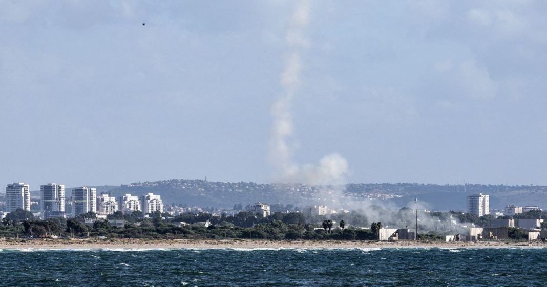 A plume of smoke billows after missiles were fired from Israel's Iron Dome missile-defense system batteries to intercept rockets over the northern city of Acre on Tuesday.