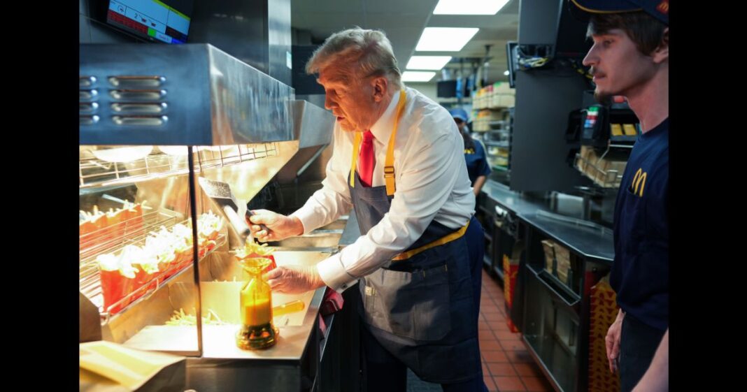 Republican presidential nominee, former U.S. President Donald Trump works behind the counter making french fries during a campaign event at McDonald's restaurant on October 20, 2024 in Feasterville-Trevose, Pennsylvania.