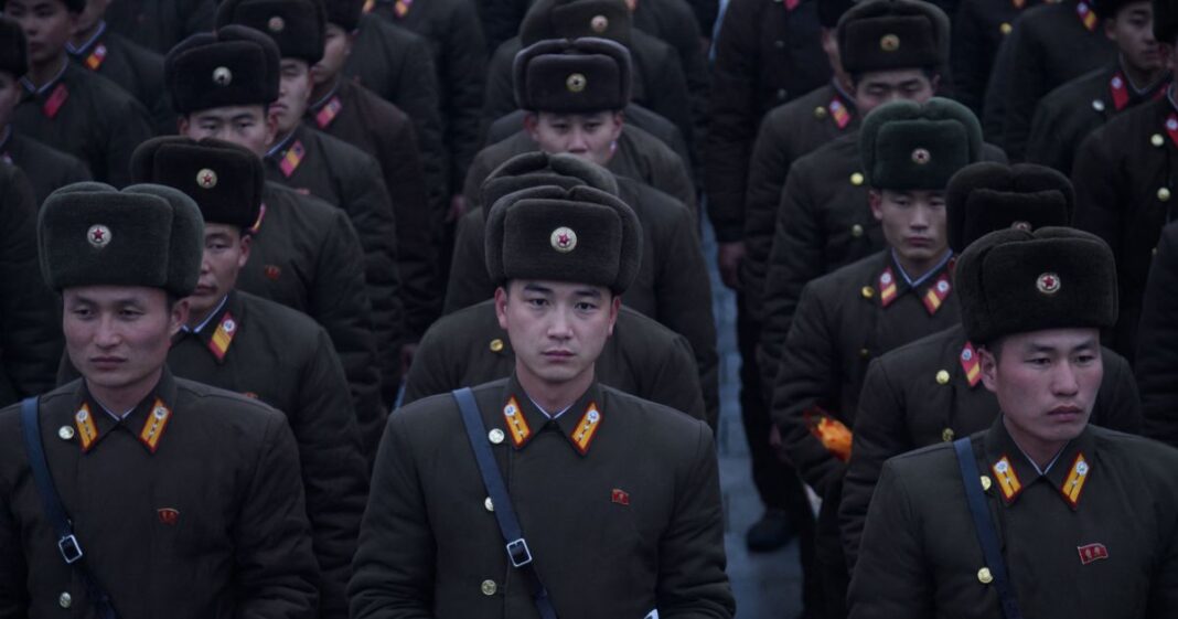 In a photo taken on December 17, 2019 Korean People's Army (KPA) soldiers hold flowers as they pay their respects before a statue of late North Korean leader Kim Jong Il, on the anniversary of his death, at Mansu Hill in Pyongyang.