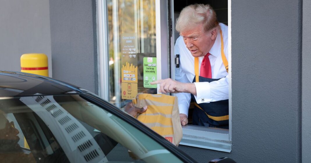 Republican presidential nominee, former U.S. President Donald Trump works the drive-through line as he visits a McDonald's restaurant on October 20, 2024 in Feasterville-Trevose, Pennsylvania.