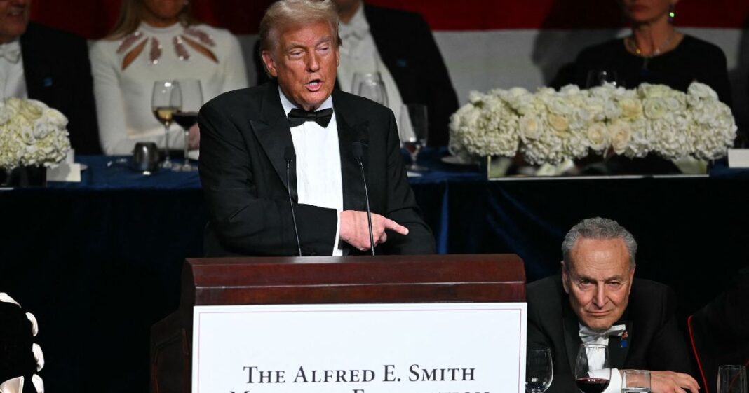 Former President Donald Trump, left, gestures to Senate Majority Leader Chuck Schumer, right, during his speech at the Al Smith Dinner in New York City on Thursday.