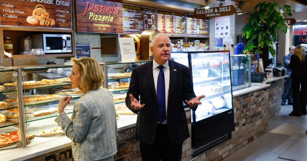 Democratic vice presidential candidate Minnesota Gov. Tim Walz and his wife Gwen Walz , left, visit Justino's Pizzeria after his debate with Republican vice presidential candidate Sen. JD Vance of Ohio Tuesday in New York City.